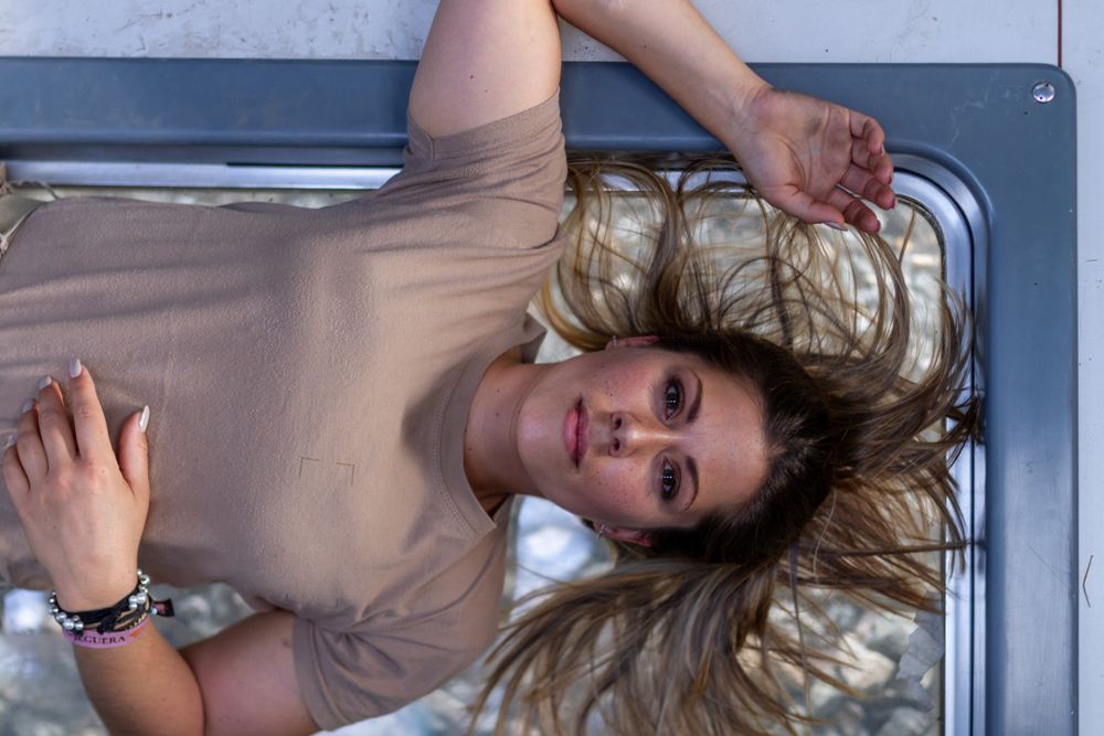 Military woman lying on window