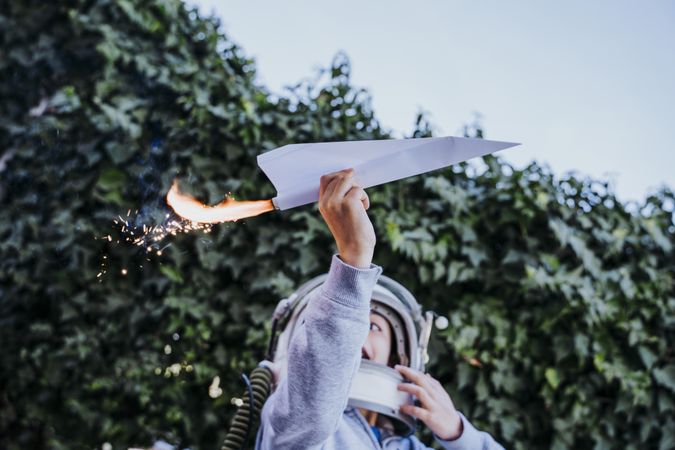 Surprised kid having fun with sparkling airplane