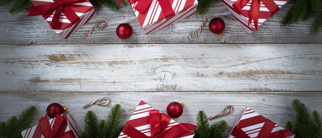 Merry Christmas holiday top and bottom borders on weathered wooden background