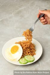 Person lifting noodles with fork 4ON6g5