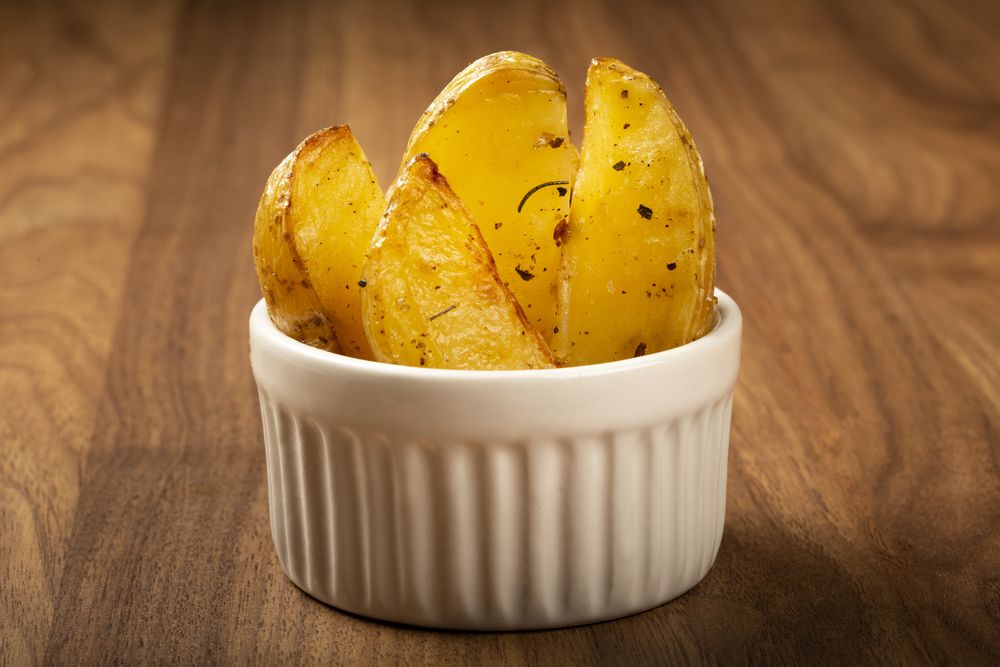 Roasted potatoes with rosemary on the plate.