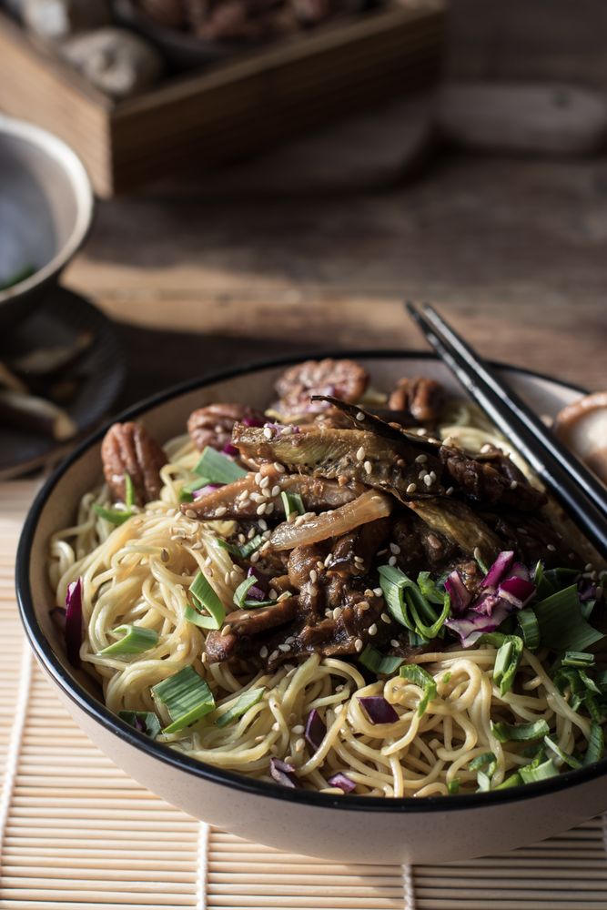 Miso noodles with egg plants and shiitake in bowl on table