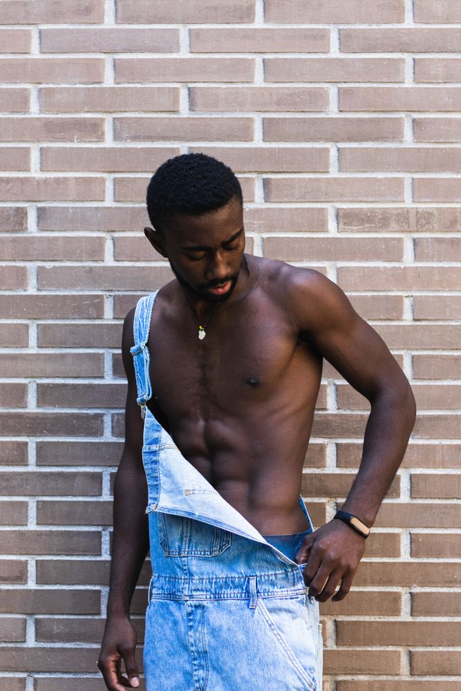 Fit Black man in overalls in city