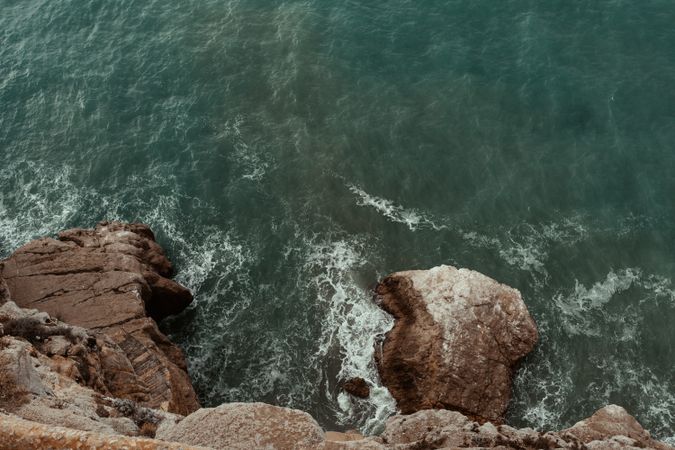 Sea waves hitting rocky cliff