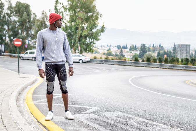 Fit male standing on city street