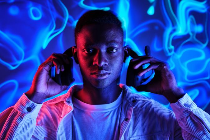 Serious Black man taking on wireless headset