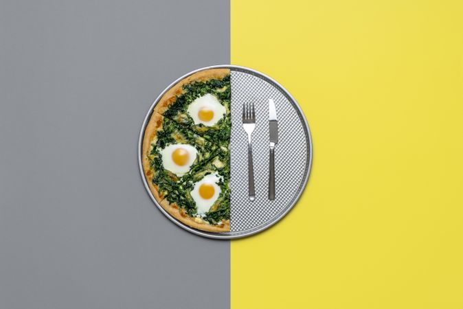 Top view of vegetarian pizza with egg and spinach