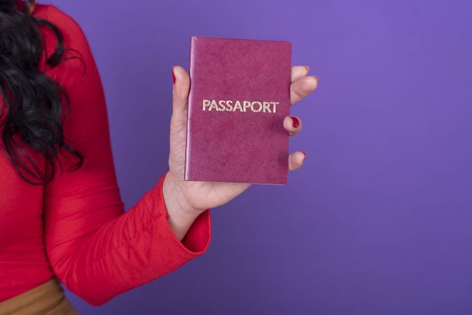 Female hand holding a passport