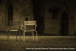Two empty chairs in street 5w9xvb