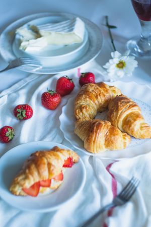 Crescent shaped croissants enjoyed with fruit and cheese