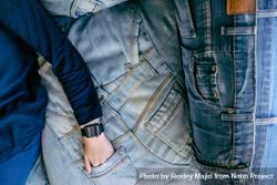 Anonymous person lying on denim with hand in pocket 5l6O7b