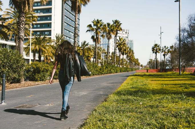 Teen girl walking happily through the streets.