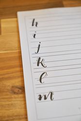 Letter drawing schemes on wooden table