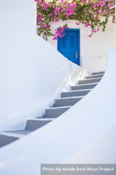 Stairs, blue door and pink flowers, vertical 4BDMk0