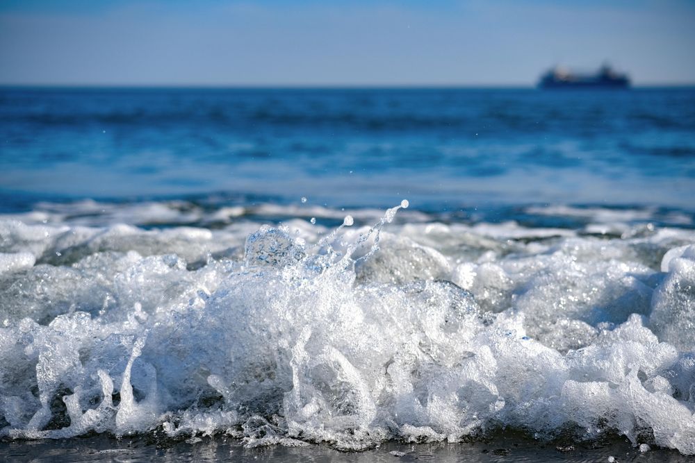 Waves coming in from the ocean onto shore in Japan