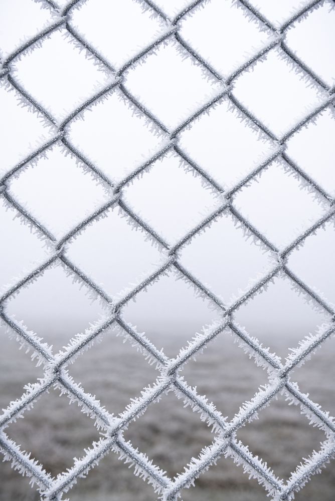 Metal fence with fresh ice