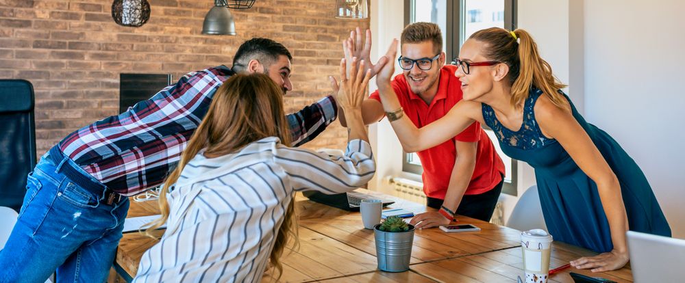Businesspeople celebrating a success high-fiving