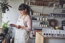 Florist working with tablet in her shop