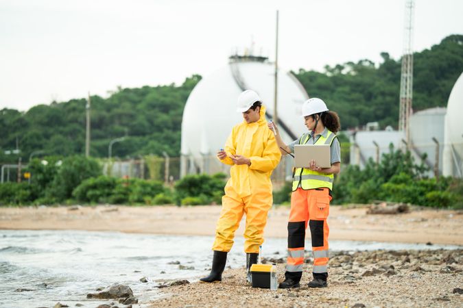 Environment scientist with team analysing waste water collecting sample for research