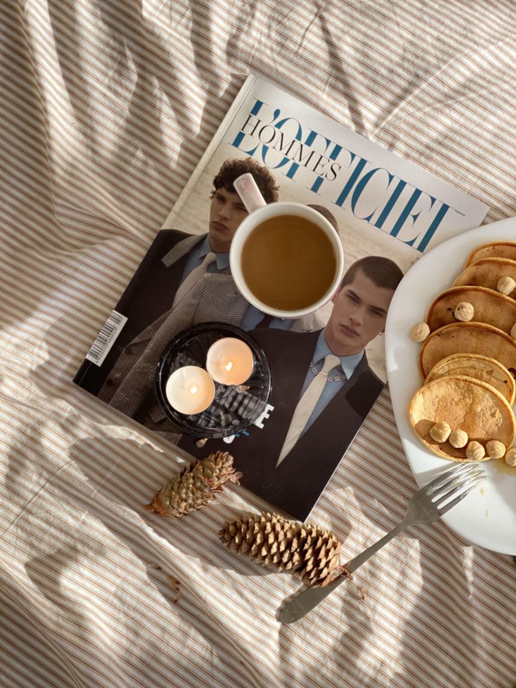 Top view of magazine, coffee, candles and breakfast