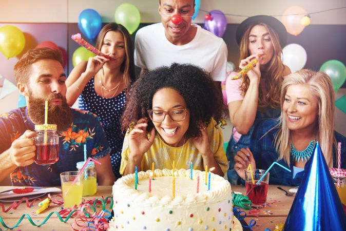 Woman ready to blow out her birthday candles at a party