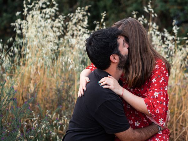 Young happy couple embracing in beautiful garden