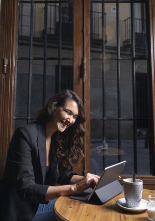 Young female using digital tablet in cafe