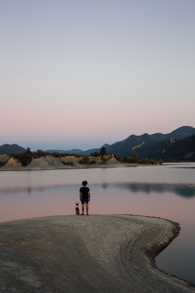 Male hiker with his pet observing nature