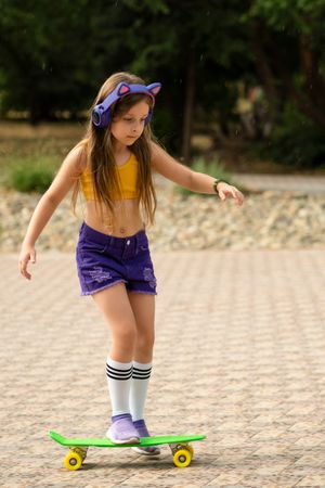 Fashionable Female Child with Skateboard