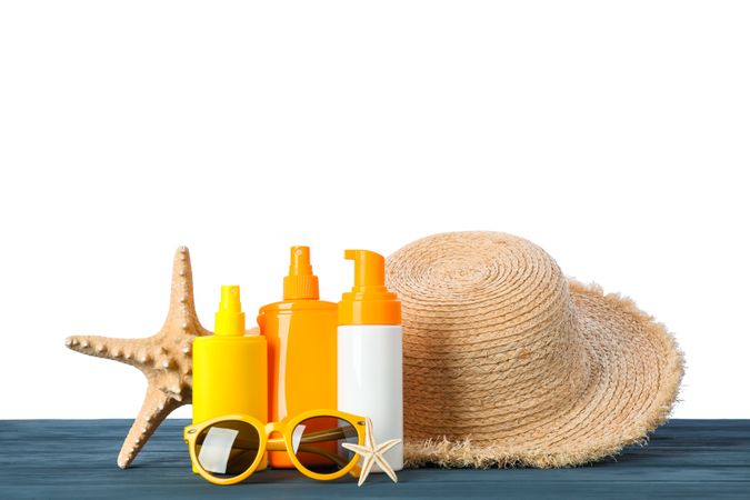 Summer vacation accessories on wooden table isolated on studio background. Happy holidays