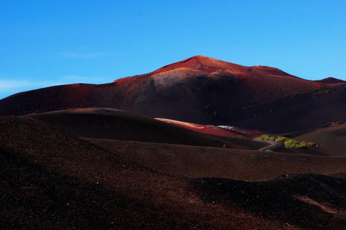 Picturesque view of volcanic terrain with solidified lava in wild area