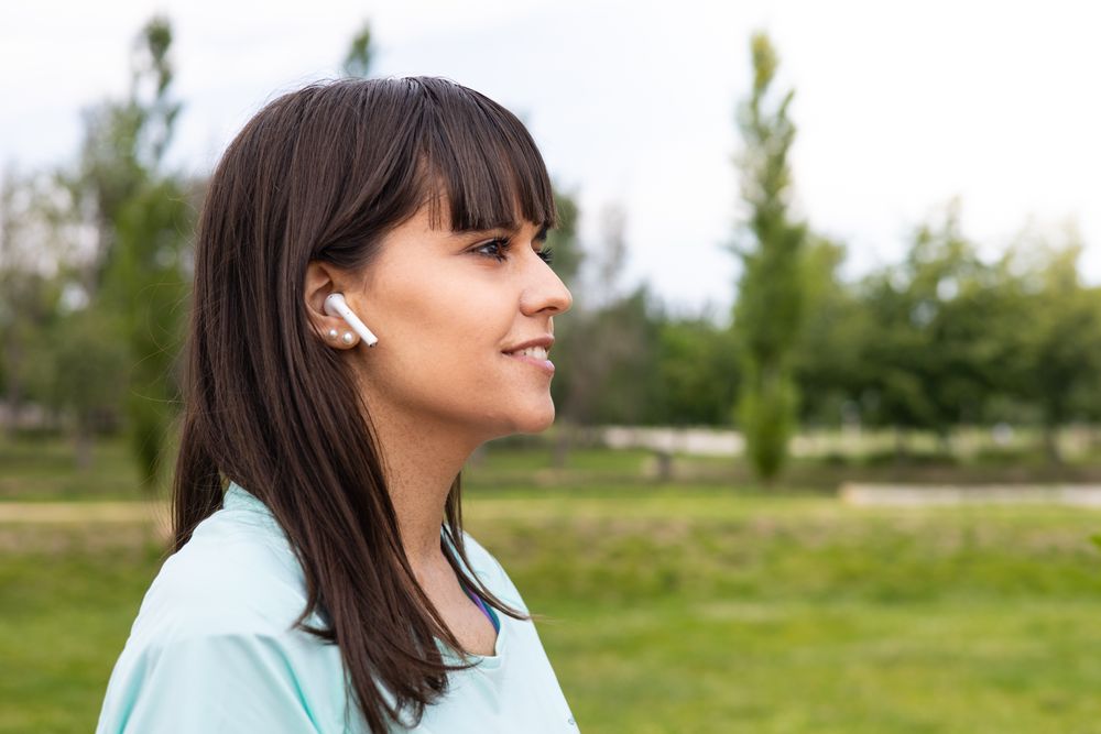Runner woman relaxed listening to music for training outdoors