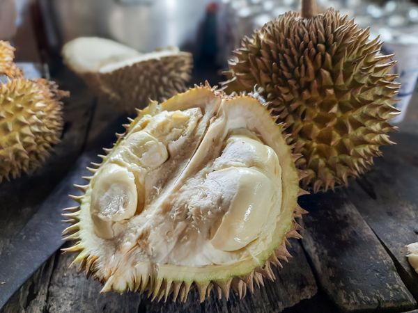 Opened Ripe Durian Fruit on a Wooden Table