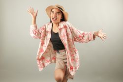Positive Asian Female Tourist Wearing Summer Holiday Beach Shirt and Hat Feels Happiness