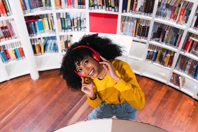 Portrait of cheerful Black woman in headphones