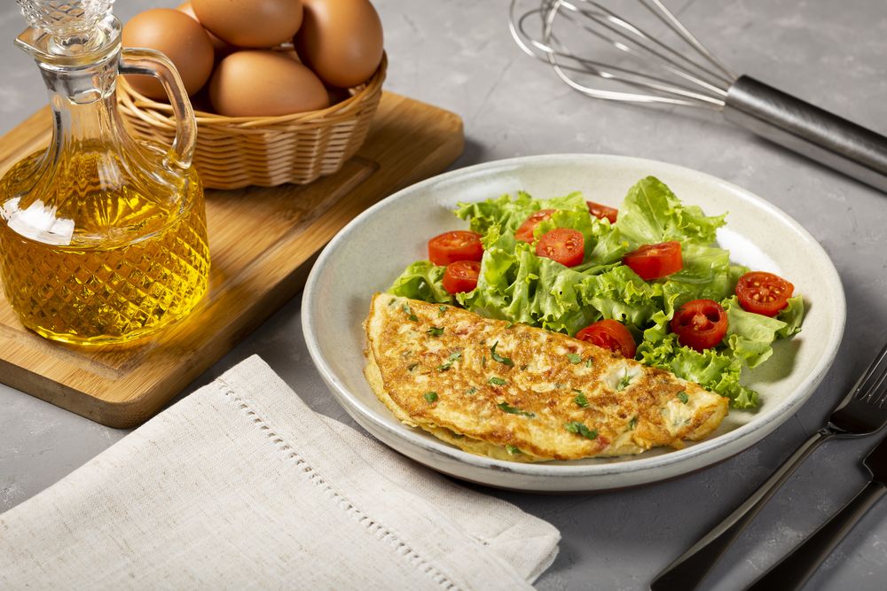 Omelet with cheese and lettuce and tomato salad.