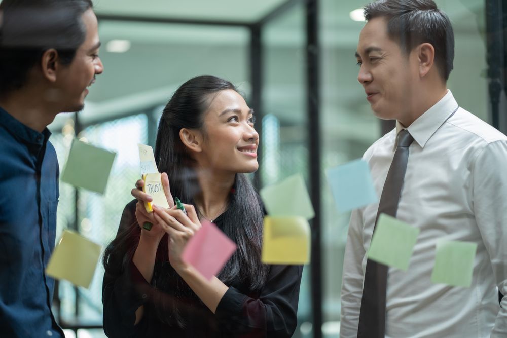 Business colleagues brainstorming with sticky notes in office