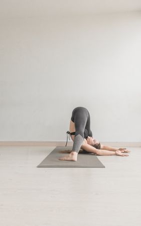 Flexible woman stretching in studio