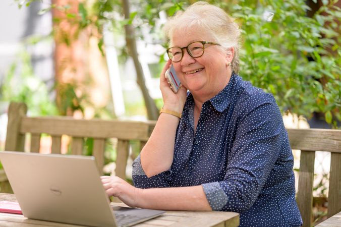 Happy older woman talking on the phone