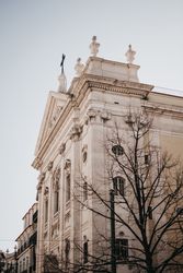Corner of building against cloudy sky