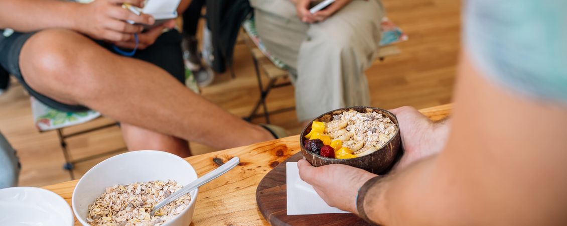Banner of chef showing vegan bowl to audience taking notes in healthy cooking master class