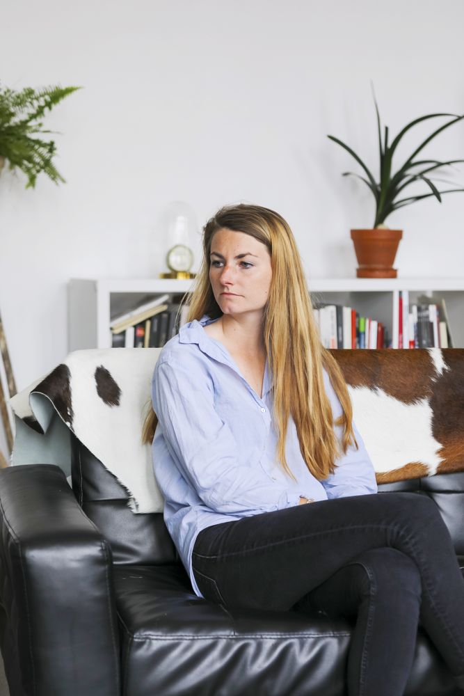 Portrait of blonde woman sitting on sofa