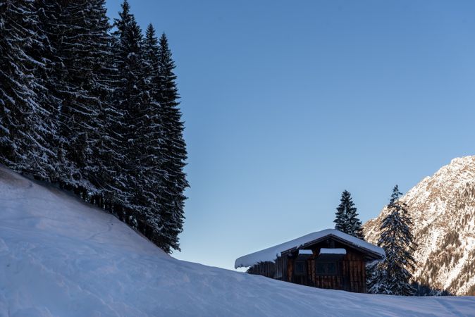 Rustic mountain cottage in deep snow in the Bavarian Alps, Germany