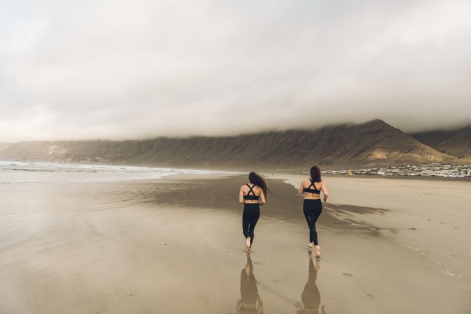Anonymous women running near sea