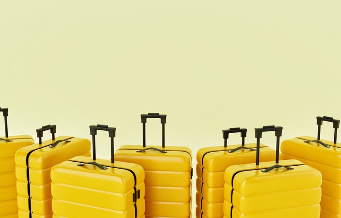 Yellow hard shell roller suitcases in a pastel yellow room