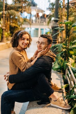 Young couple embracing on bench