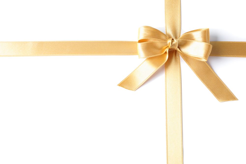 Golden ribbon with bow isolated on plain background. Gift concept