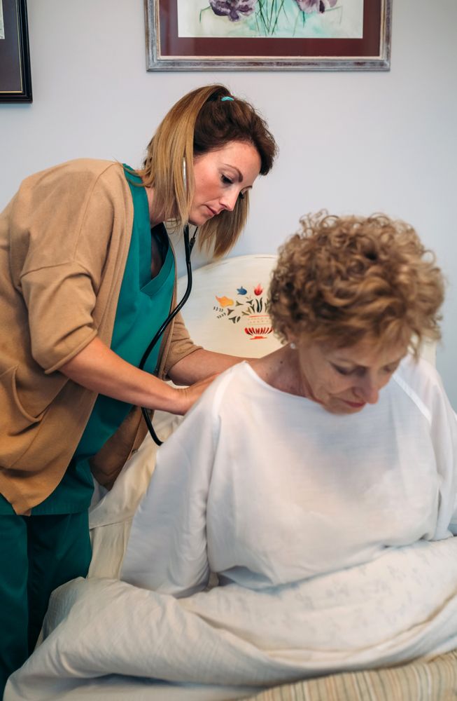 Caregiver auscultating woman