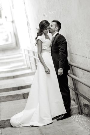 Loving newlyweds standing on outdoor steps