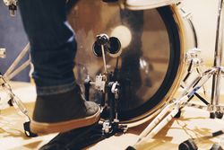 Man playing on drum pedal